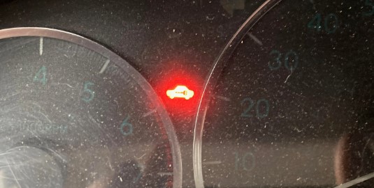 Red Car With Key Symbol On Dashboard